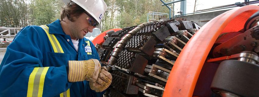 FortisBC worker works to repair machinery