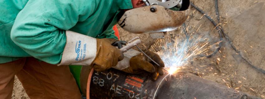 Welder works on gas line