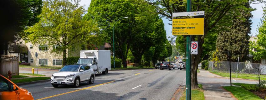 Gas line construction sign along a busy roadway