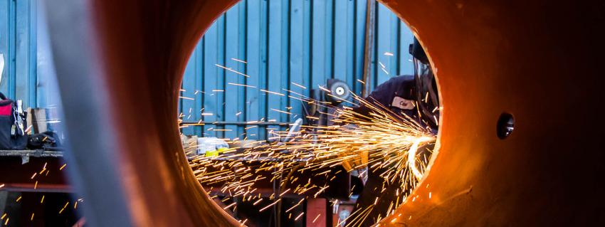 Looking through a pipe at a welder