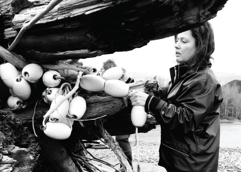 Sarah Schreier, Executive Director of the Fraser River Sturgeon Conservation Society, removes some ghost gear from a stump