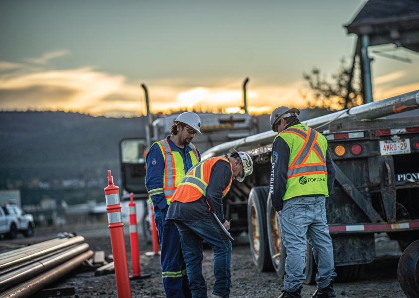 (L to R) Shane Gravelle consults with Wayne Attfield and Jamie Peterson at a project site. 