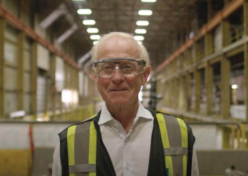 Jim Longo, President, Ideal Welders wears safety glasses and vest and smiles at the camera