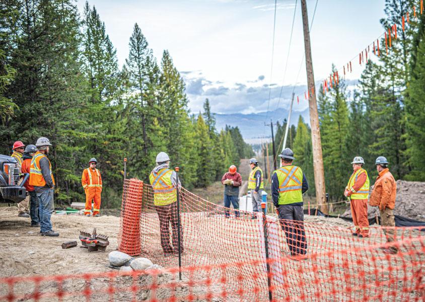 workers gather for a tailgate meeting on a worksite