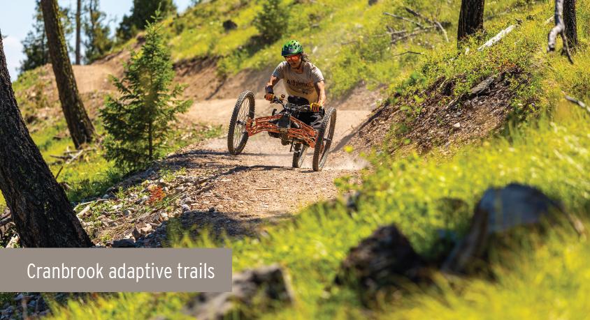 A rider on an adaptive bike rides a trail in Cranbrook