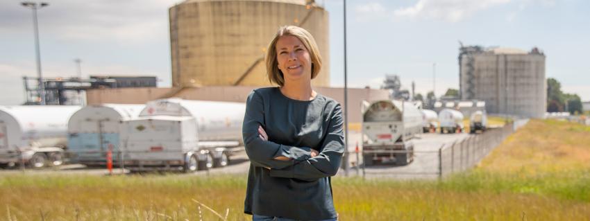 Courtney Hodson sanding in front of Tilbury LNG facility